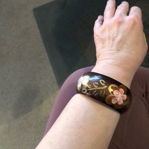 Wooden bracelet with handpainted flower.